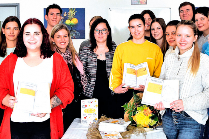 Die Fachvorständin Verena Deutsch (Mitte) mit einigen MaturantInnen bei der Präsentation des Kochbuches. 